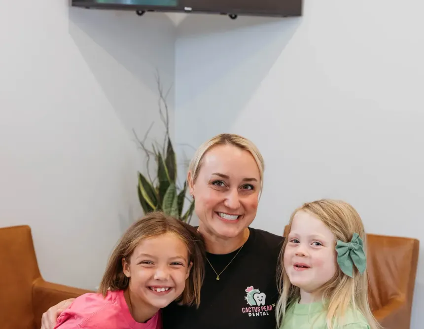 Dr. Kim Oberlander in the waiting room with two young patients