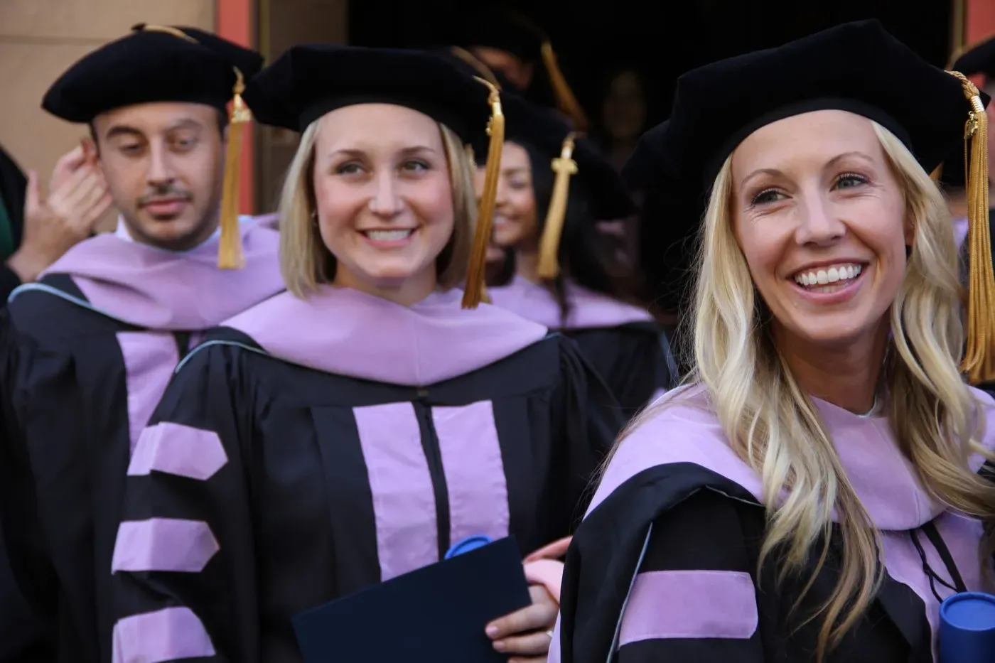 Dr. Oberlander at her graduation, in cap and gown with classmates
