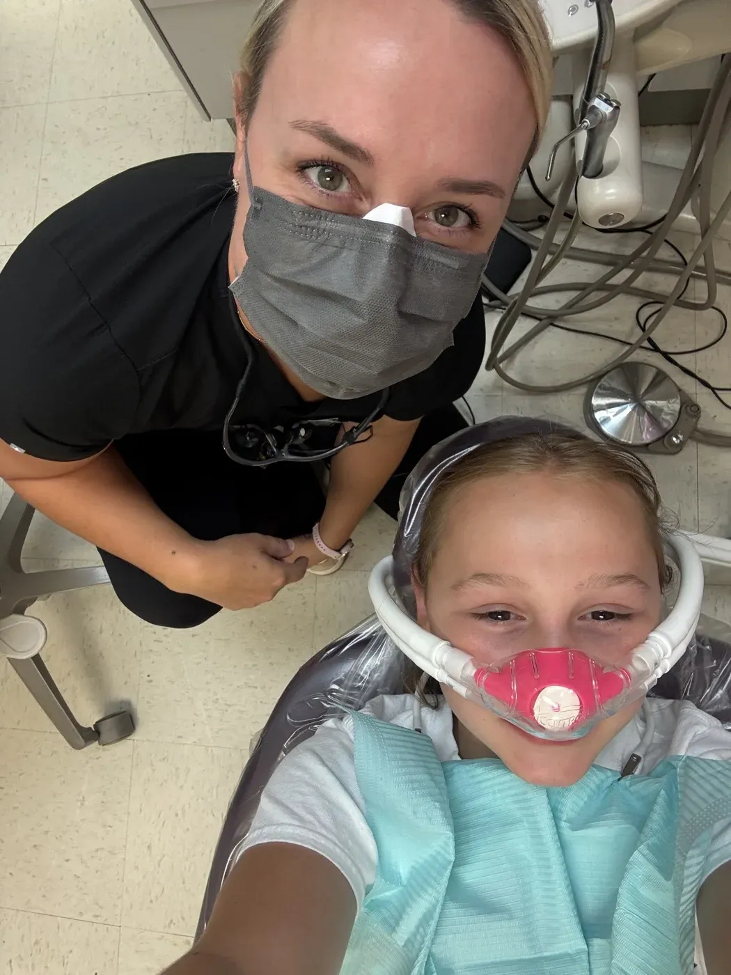 Dr. Oberlander beside a young patient settled in the chair