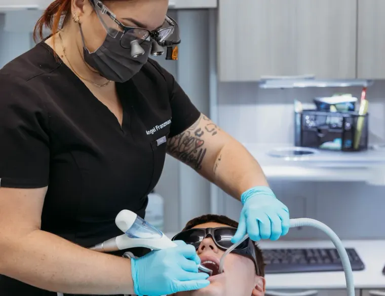 A patient wearing protective glasses during a cleaning